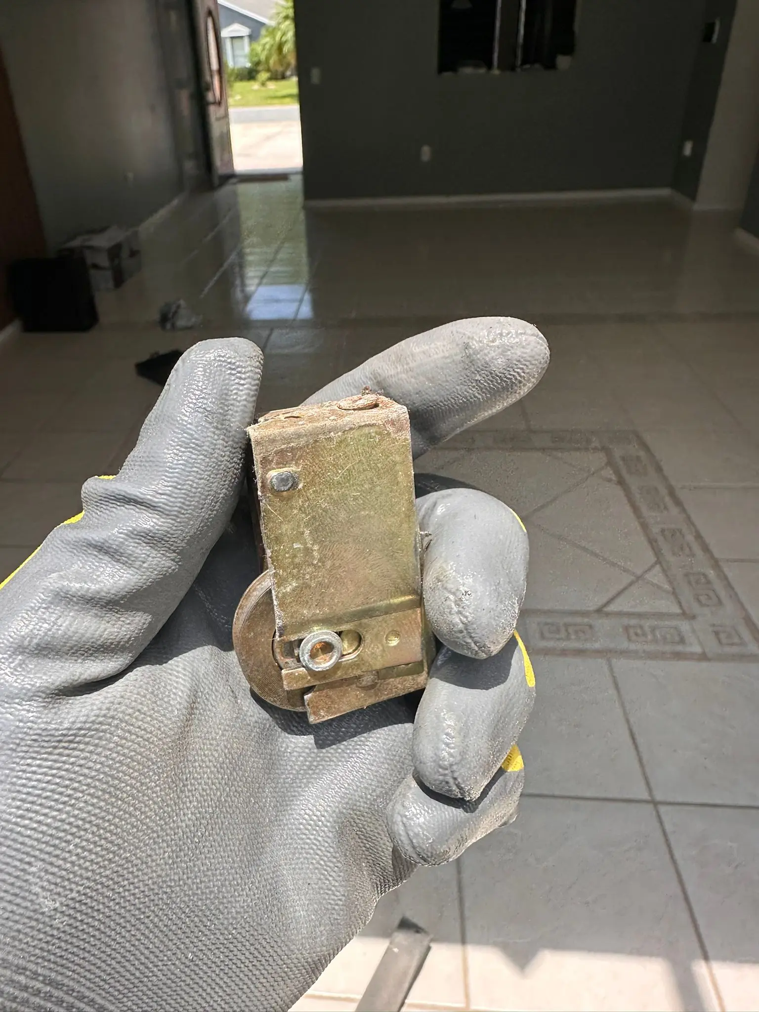 Worn pocket door roller with visible flat spots and corrosion from years of use